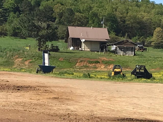 Farm House With Equipment Outside